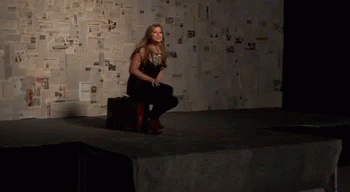 Woman Sitting on Suitcase Screaming