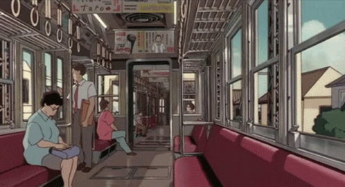 Woman Sitting on Train Looking at Phone