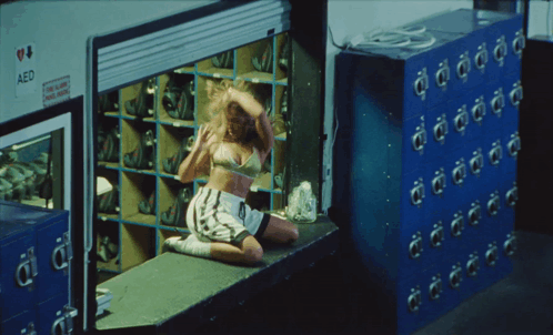 Woman Sitting on Window Sill in Front of AED Locker