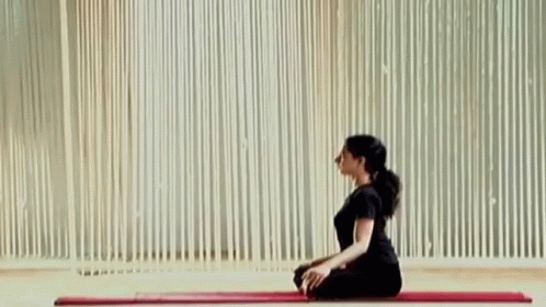 Woman Sitting on Yoga Mat