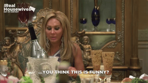 Woman Sitting With Champagne Bucket And Saying You Think This Is Funny GIF