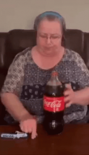 Woman Sitting With Coca Cola Bottle and Lighter