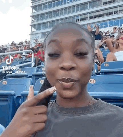 Woman Sitting with Eyes Closed and Making Face