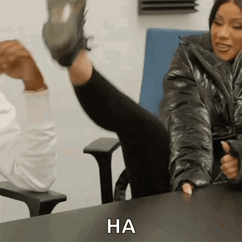 Woman Sitting With Leg Up Saying Ha