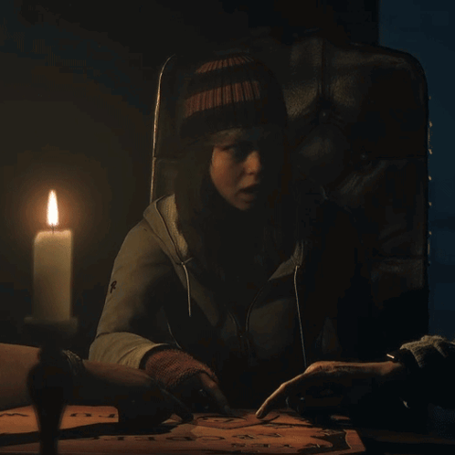 Woman Sitting With Lit Candle Cross Jacket GIF