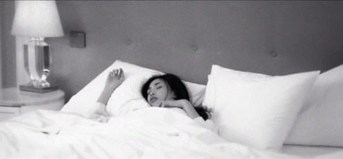 Woman Sleeping On Bed With White Sheets GIF
