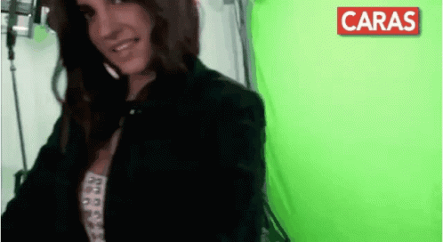 Woman Smiles at Green Screen With Red Caras