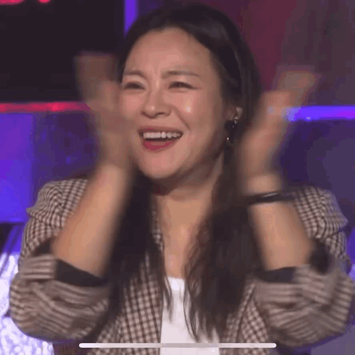 Woman Smiling And Clapping In Plaid Jacket GIF