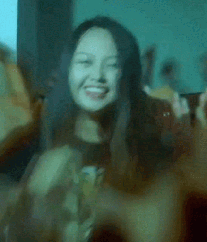 Woman Smiling and Making Peace Sign