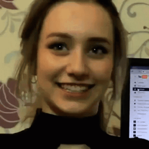 Woman Smiling at Computer Screen with YouTube