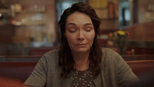 Woman Smiling at Diner Table
