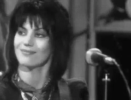 Woman Smiling at Microphone