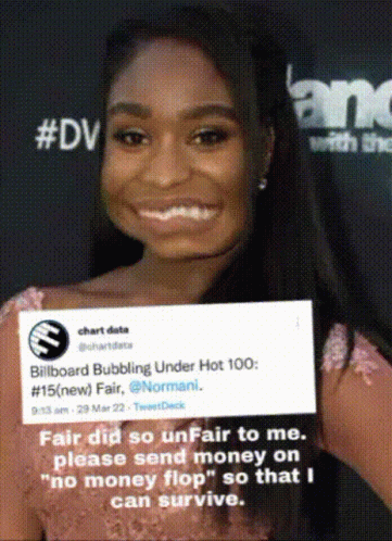 Woman Smiling Holding Billboard Bubbling Under Hot 100 Sign