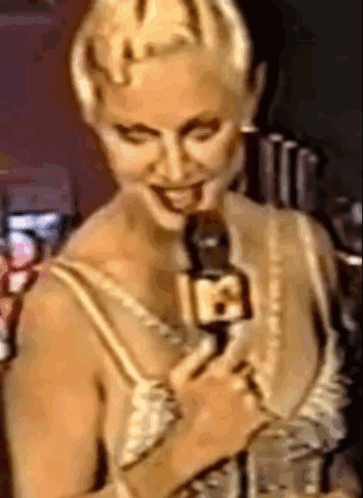 Woman Smiling Holding Microphone With Number 18