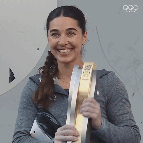 Woman Smiling Holding Olympics Trophy GIF