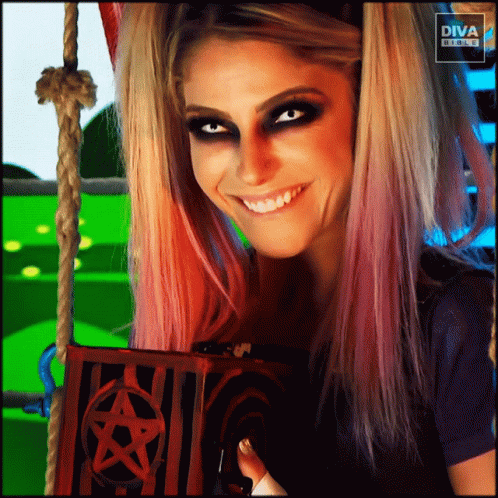 Woman Smiling Holding Pentagram Box in Front of Diva Banner