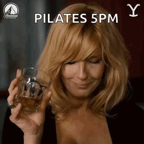 Woman Smiling Holding Whiskey Glass Pilates 5pm