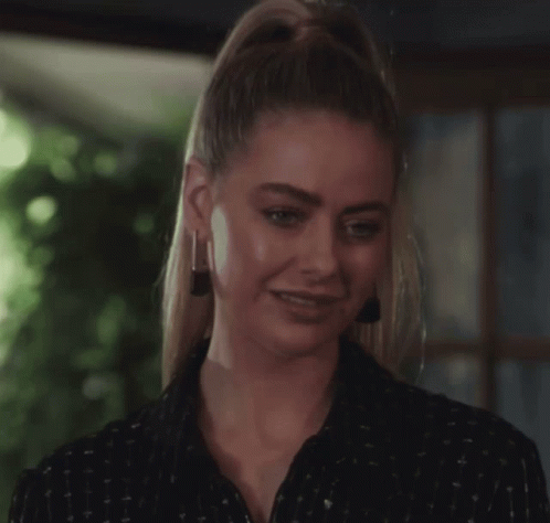 Woman Smiling in Black Shirt and Earrings