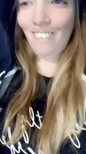 Woman Smiling in Black Shirt Saying Built