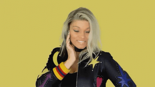 Woman Smiling in Colorful Star and Heart Jacket