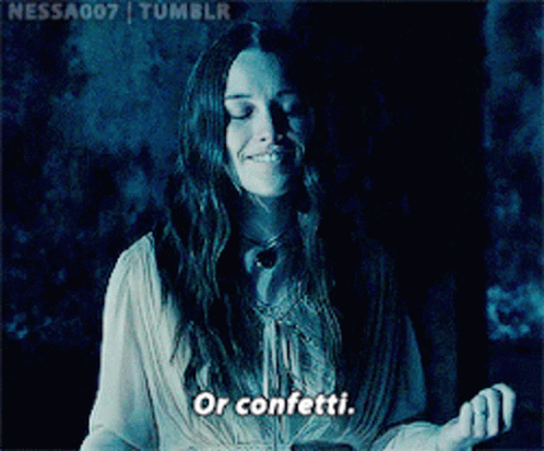 Woman Smiling In Dark Room Saying Confetti GIF