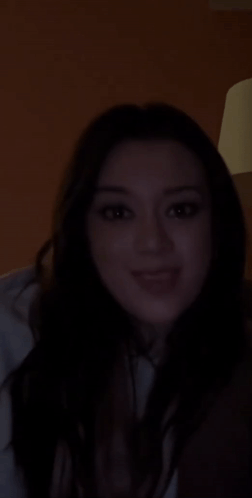 Woman Smiling in Dark Room