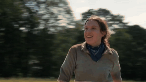 Woman Smiling in Field with Bandana