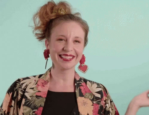Woman Smiling in Floral Jacket and Earrings