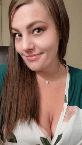 Woman Smiling in Floral Shirt and Necklace