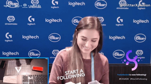 Woman Smiling in Front of Blue Background with Logitech Logos