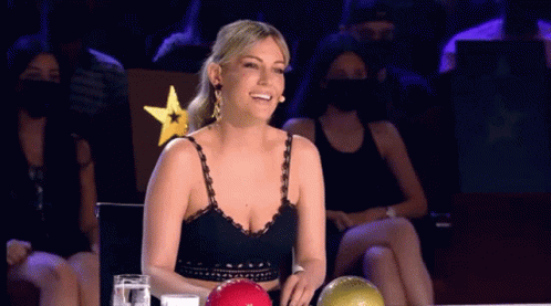 Woman Smiling in Front of Bowling Ball