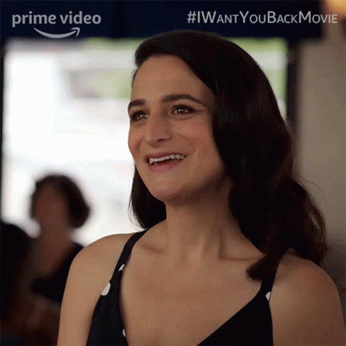 Woman Smiling In Front Of I Want You Back Sign GIF