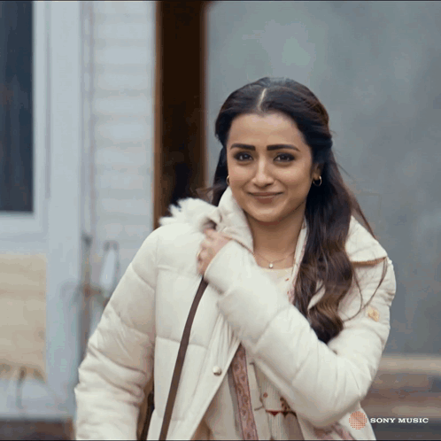 Woman Smiling in Front of Sony Music Ad