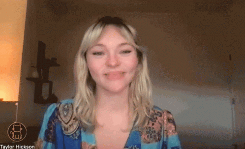 Woman Smiling In Front Of Taylor Hickson Screen GIF