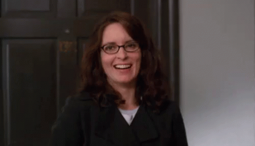 Woman Smiling in Glasses and Black Jacket