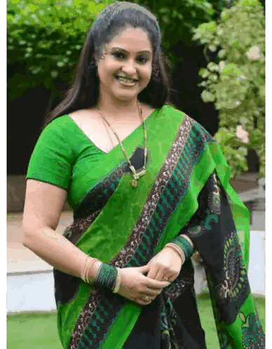 Woman Smiling in Green and Black Saree