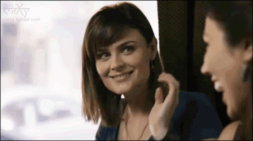 Woman Smiling in Mirror with Another Woman