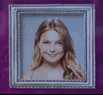 Woman Smiling in Picture Frame on Purple Wall