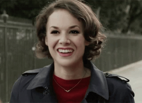 Woman Smiling in Trench Coat and Necklace