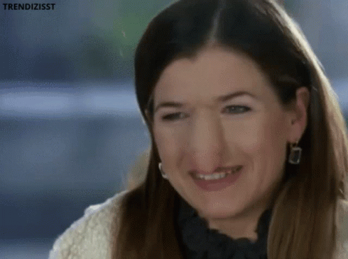 Woman Smiling in White Sweater