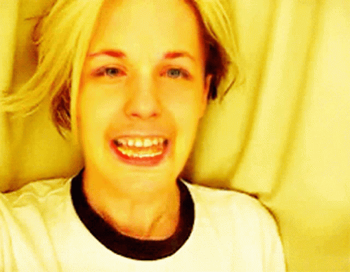Woman Smiling in White T-Shirt and Black Collar