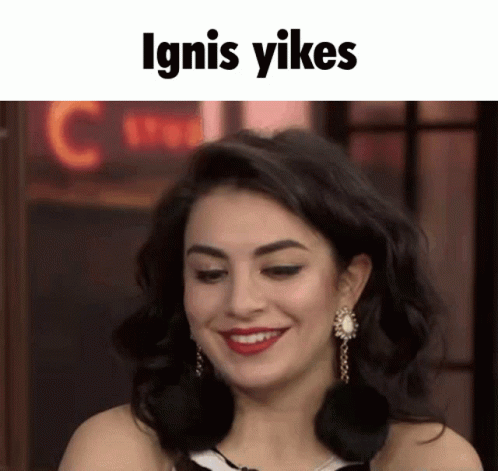 Woman Smiling Near Ignis Yikes Neon Sign