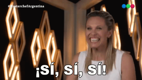 Woman Smiling Next to Si Si Si Sign
