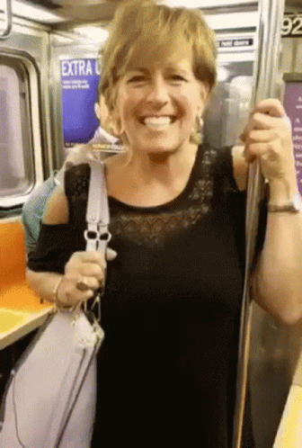 Woman Smiling on Subway With Extra Sign