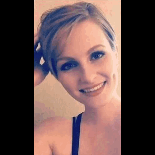 Woman Smiling Touching Hair