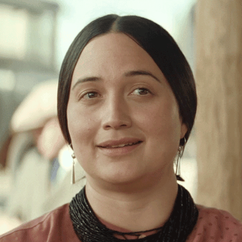 Woman Smiling With Black Necklace And Earrings GIF