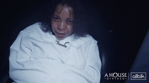 Woman Smirking In Straight Jacket GIF