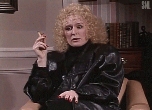 Woman Smoking Cigar In Chair SNL GIF