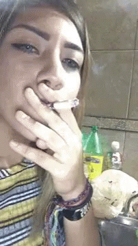 Woman Smoking Cigarette at Sink