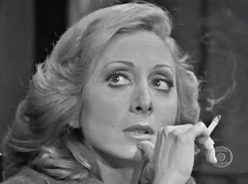 Woman Smoking Cigarette In Black And White GIF